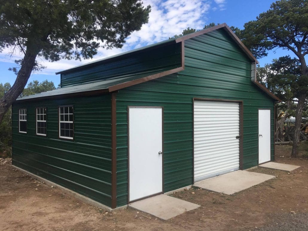 A dark green steel garage with white doors