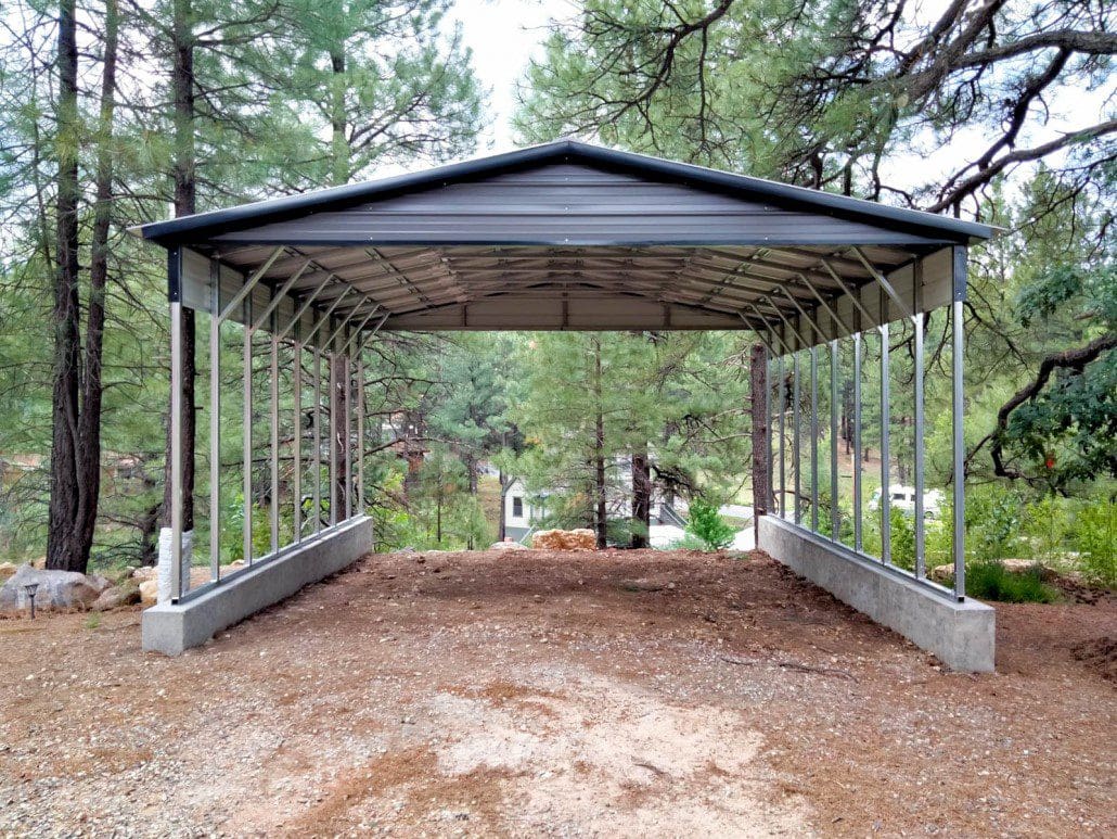 An RV and carport in the woods