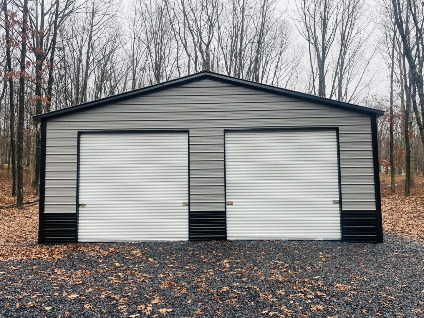 A metal/steel garage that is pewter grey with black trim and wainscoting